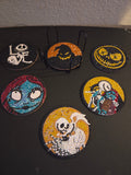 Six round Nightmare Before Christmas diamond art coasters displayed beside a black holder.