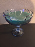 Mint sage soy wax candle with green wax in a scalloped glass pedestal bowl.
